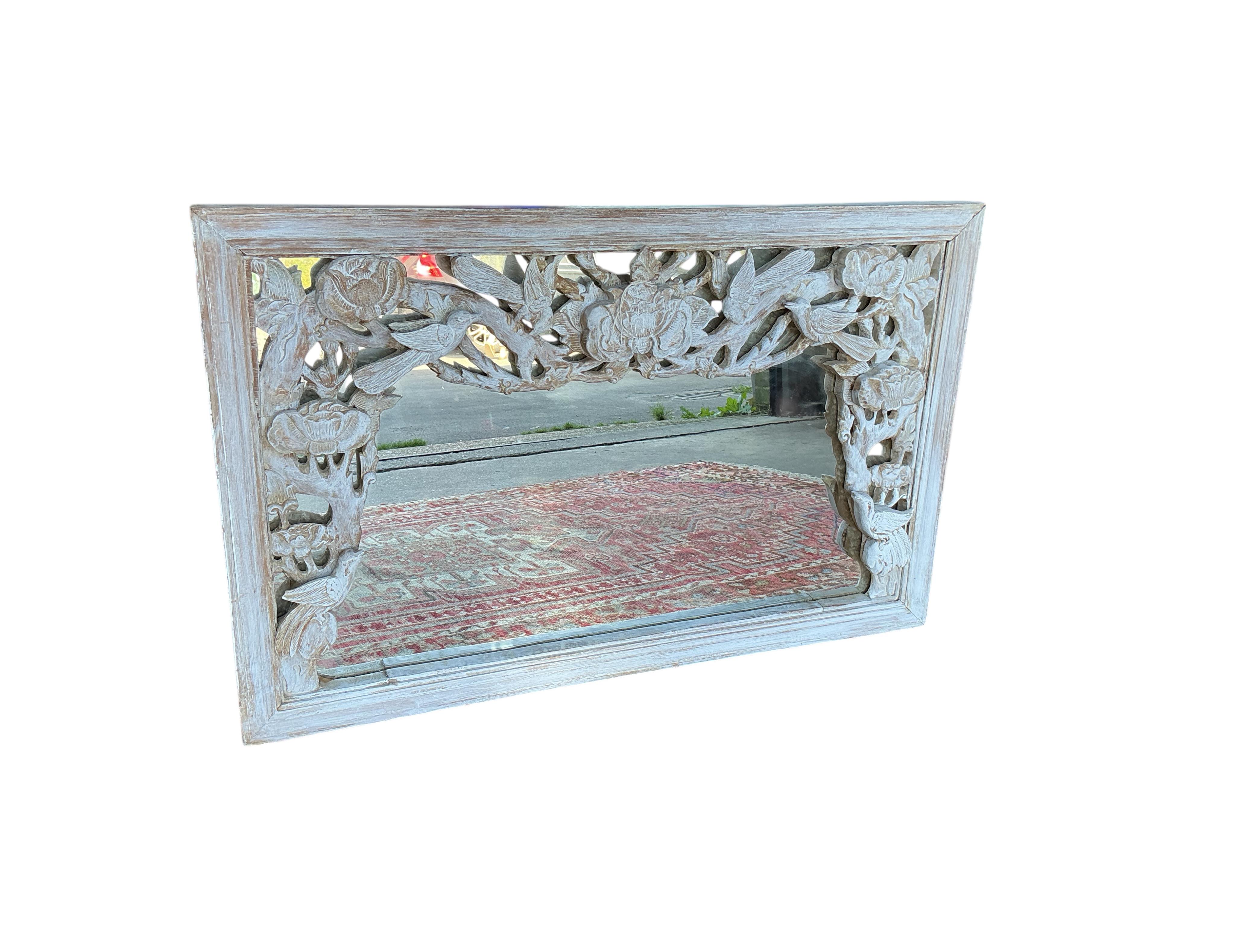 A Chinese carved hardwood wall mirror, later painted, width 93cm, height 60cm
